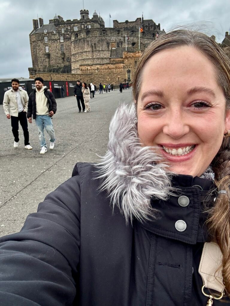Person in front of Edinburgh castle.