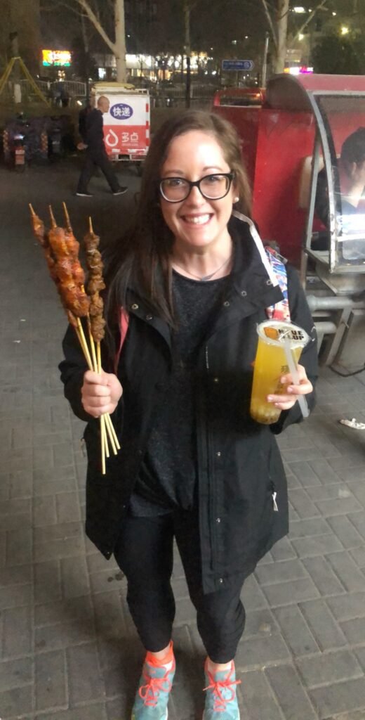Trying traditional Chinese street food skewers at a Beijing night market