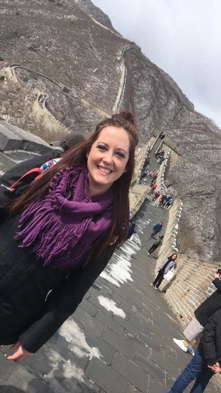 Walking on the Great Wall of China winding through mountain landscape.