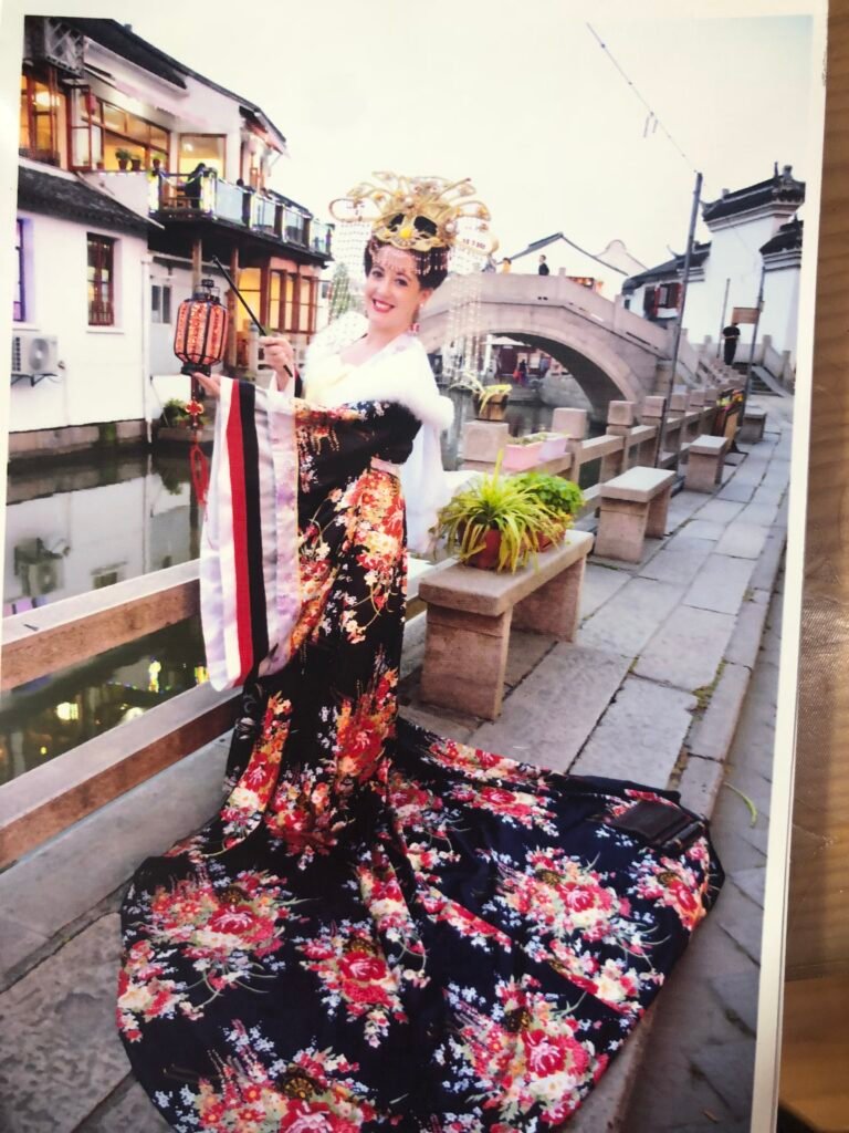 Woman wearing traditional Chinese hanfu clothing in an ancient water town.