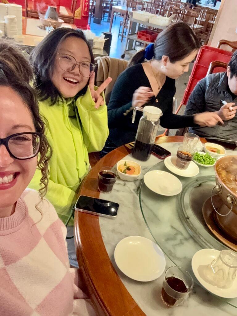 Sharing a traditional Chinese meal with friends at a restaurant in China.